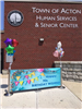 Banner showing Happy Birthday in front of Senior Center Building