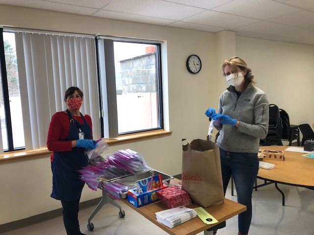 Bernice and Elizabeth filling packets